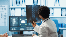 physician-reviewing-mri-scan-x-ray-results-with-patient-medical-office.jpg