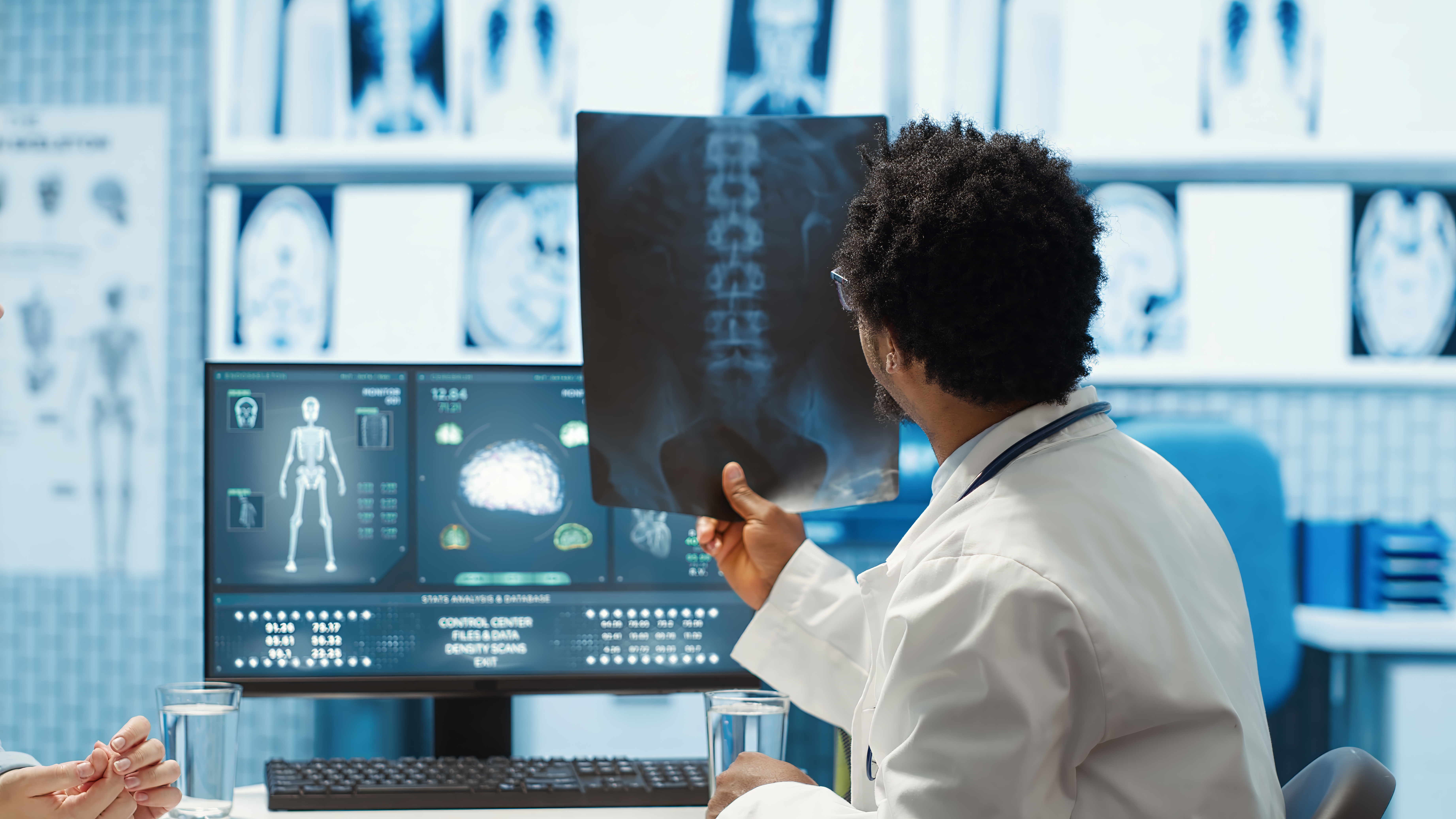 physician-reviewing-mri-scan-x-ray-results-with-patient-medical-office.jpg physician-reviewing-mri-scan-x-ray-results-with-patient-medical-office.jpg